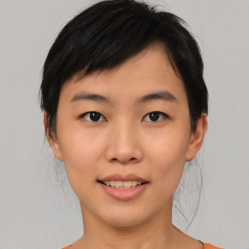Joyful asian young-adult female with medium  black hair and brown eyes