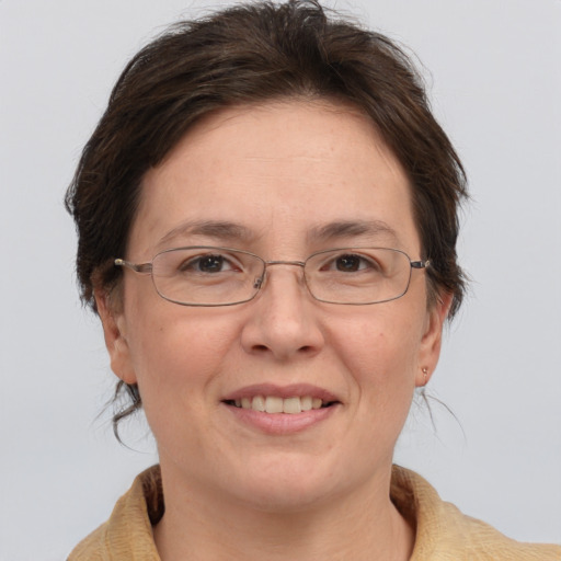 Joyful white adult female with medium  brown hair and grey eyes