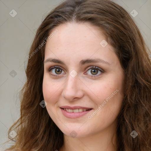 Joyful white young-adult female with long  brown hair and green eyes