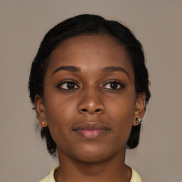 Joyful black young-adult female with medium  brown hair and brown eyes