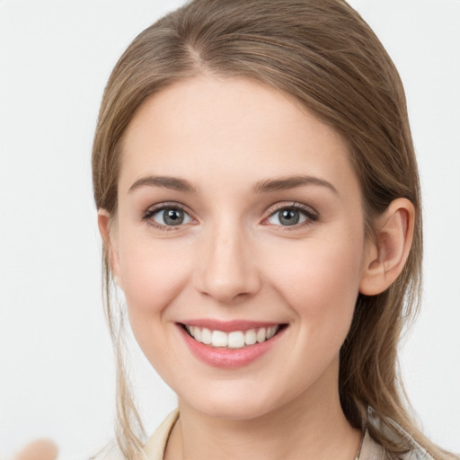 Joyful white young-adult female with long  brown hair and grey eyes