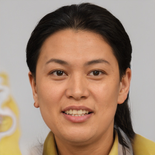 Joyful asian adult female with short  brown hair and brown eyes