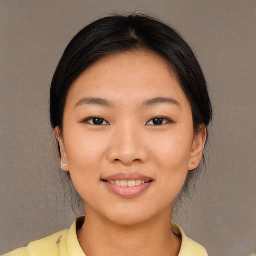 Joyful asian young-adult female with medium  black hair and brown eyes