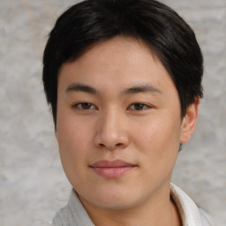 Joyful asian young-adult male with short  brown hair and brown eyes