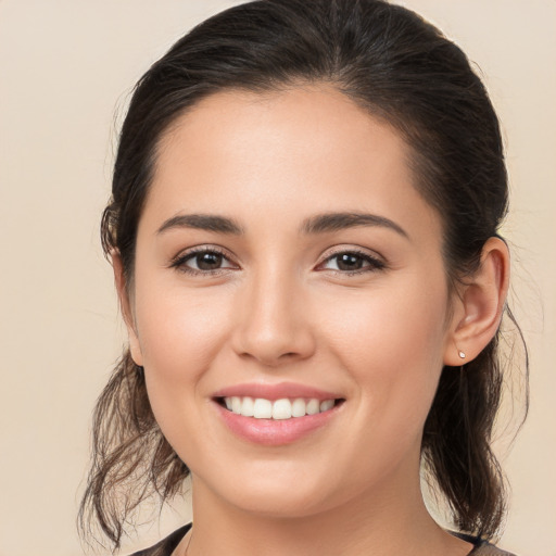 Joyful white young-adult female with medium  brown hair and brown eyes