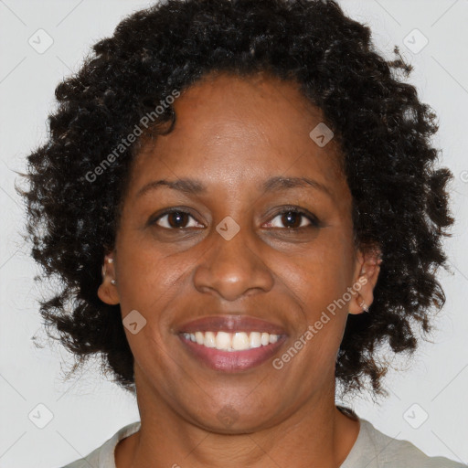 Joyful black adult female with short  brown hair and brown eyes