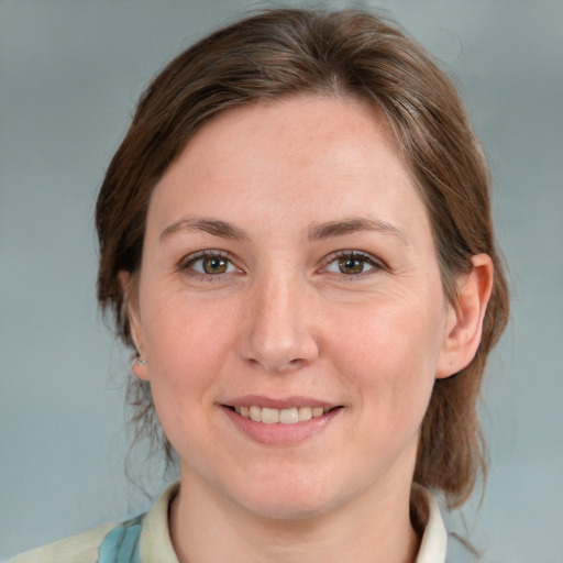 Joyful white adult female with medium  brown hair and blue eyes