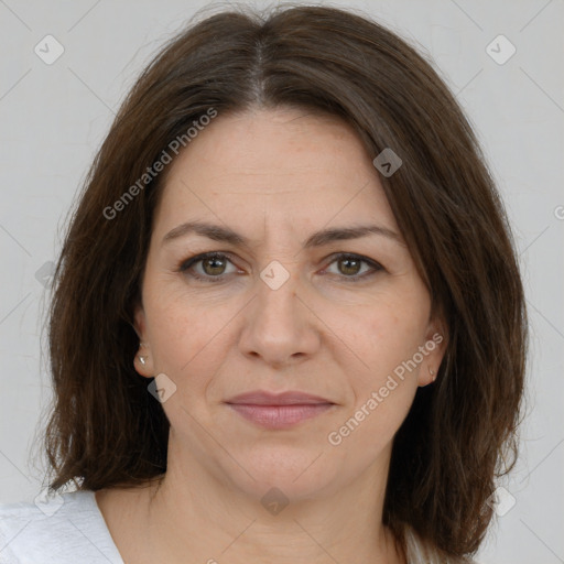 Joyful white adult female with medium  brown hair and brown eyes