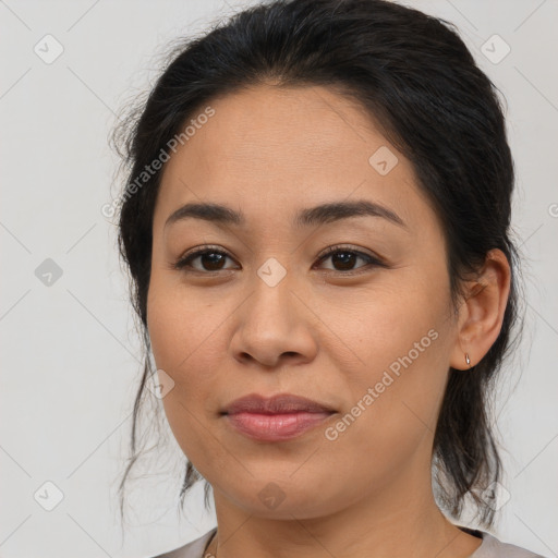 Joyful latino young-adult female with medium  brown hair and brown eyes