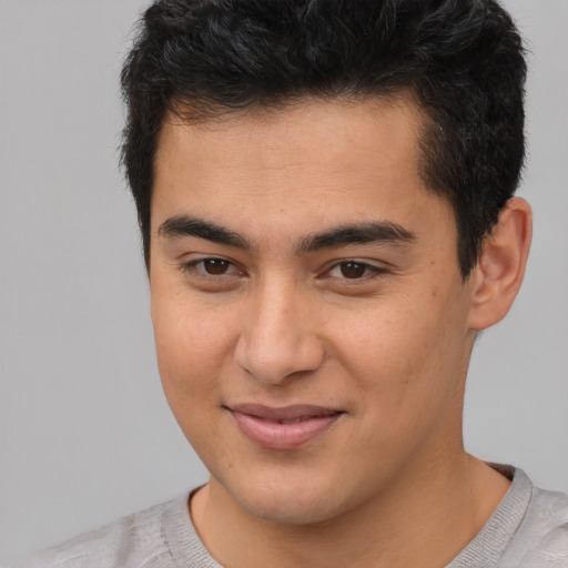 Joyful asian young-adult male with short  brown hair and brown eyes