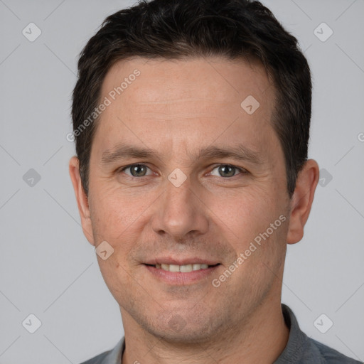 Joyful white adult male with short  brown hair and brown eyes