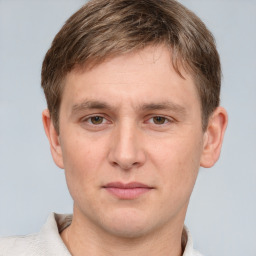 Joyful white young-adult male with short  brown hair and grey eyes