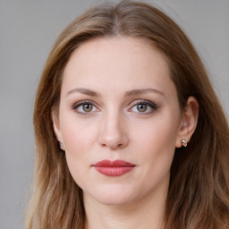 Joyful white young-adult female with long  brown hair and blue eyes