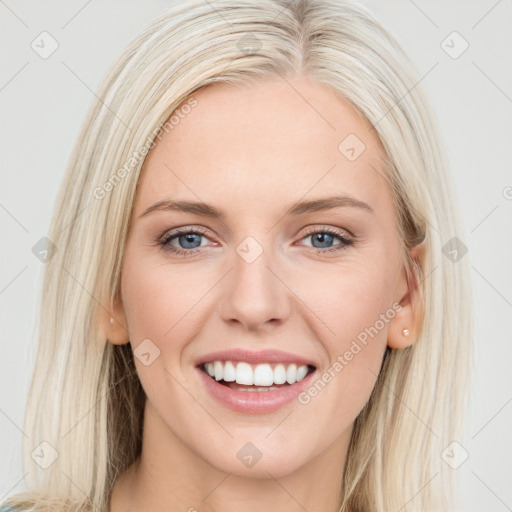 Joyful white young-adult female with long  brown hair and blue eyes