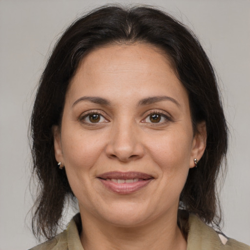 Joyful white adult female with medium  brown hair and brown eyes