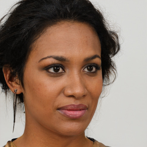 Joyful black young-adult female with medium  brown hair and brown eyes