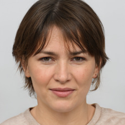 Joyful white adult female with medium  brown hair and brown eyes