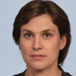 Joyful white adult female with medium  brown hair and grey eyes