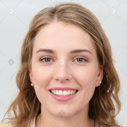 Joyful white young-adult female with long  brown hair and green eyes