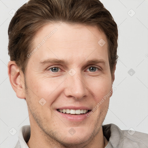 Joyful white adult male with short  brown hair and grey eyes