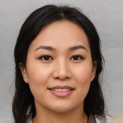 Joyful asian young-adult female with medium  brown hair and brown eyes