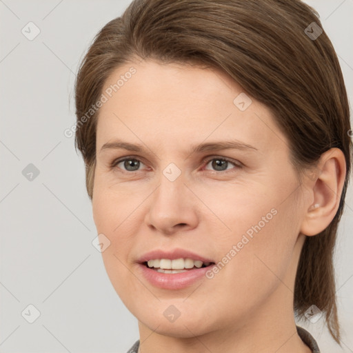 Joyful white young-adult female with medium  brown hair and grey eyes