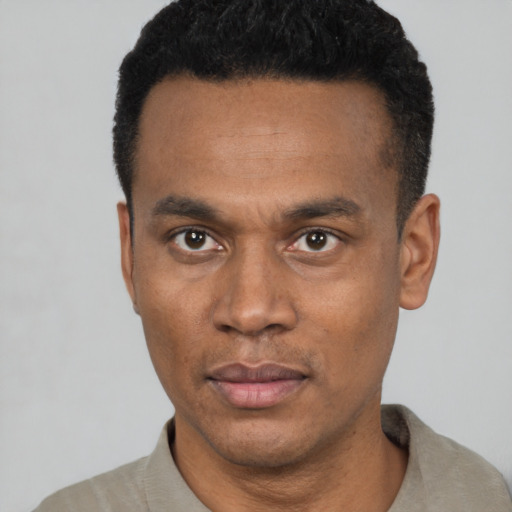 Neutral latino young-adult male with short  black hair and brown eyes