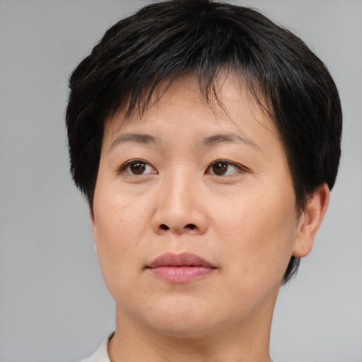 Joyful asian adult female with short  brown hair and brown eyes