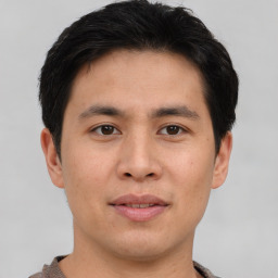 Joyful asian young-adult male with short  brown hair and brown eyes