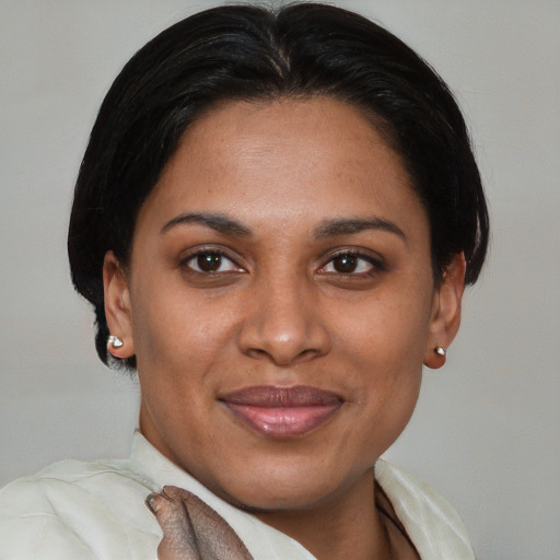 Joyful latino adult female with short  brown hair and brown eyes