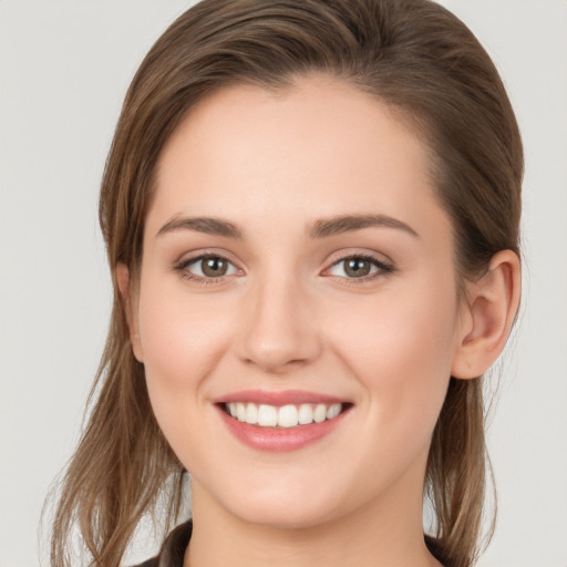 Joyful white young-adult female with long  brown hair and grey eyes