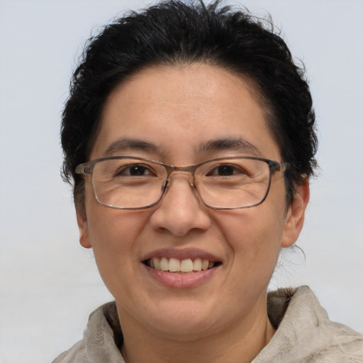 Joyful white adult female with short  brown hair and brown eyes