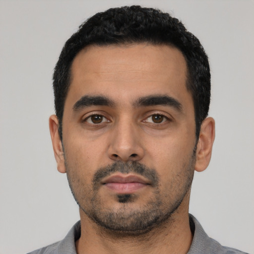 Neutral latino young-adult male with short  black hair and brown eyes