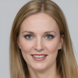 Joyful white young-adult female with long  brown hair and grey eyes