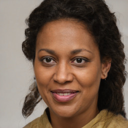 Joyful black adult female with medium  brown hair and brown eyes