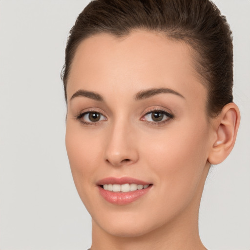 Joyful white young-adult female with long  brown hair and brown eyes