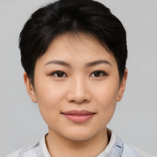 Joyful asian young-adult female with short  brown hair and brown eyes