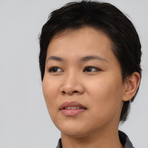 Joyful asian young-adult female with medium  black hair and brown eyes