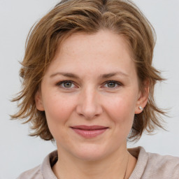 Joyful white young-adult female with medium  brown hair and blue eyes