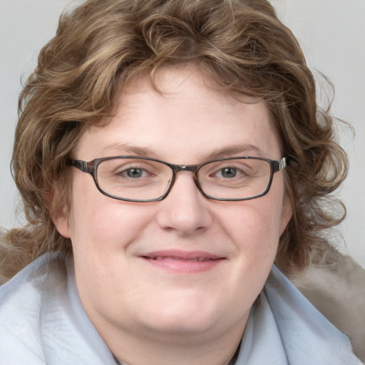 Joyful white adult female with medium  brown hair and blue eyes