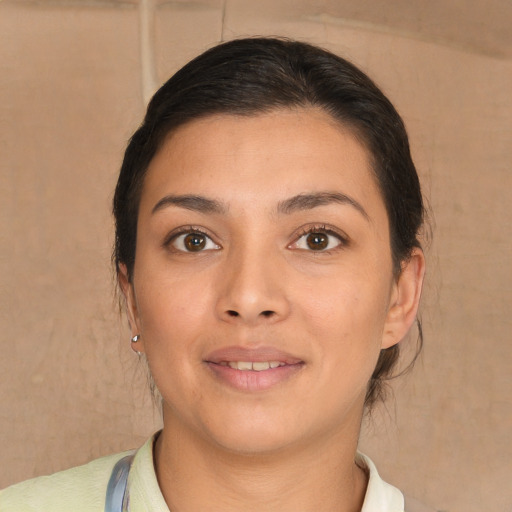 Joyful latino young-adult female with short  brown hair and brown eyes