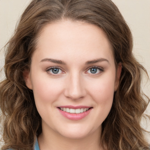 Joyful white young-adult female with long  brown hair and green eyes