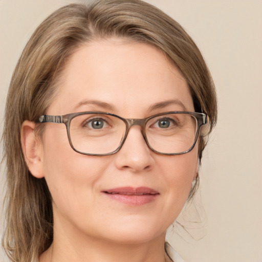 Joyful white adult female with medium  brown hair and blue eyes