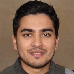 Joyful white young-adult male with short  black hair and brown eyes