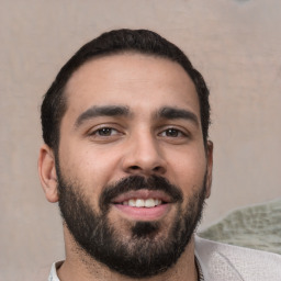 Joyful white young-adult male with short  black hair and brown eyes