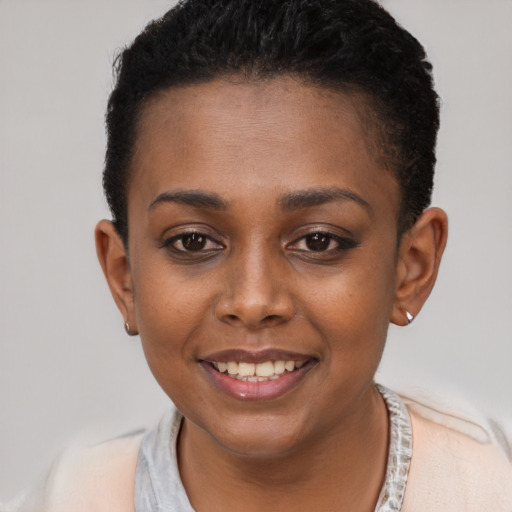 Joyful black young-adult female with short  brown hair and brown eyes