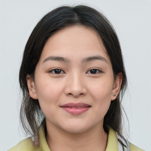 Joyful white young-adult female with medium  brown hair and brown eyes