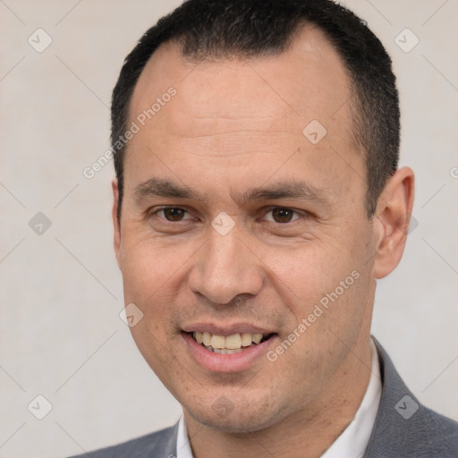 Joyful white adult male with short  black hair and brown eyes