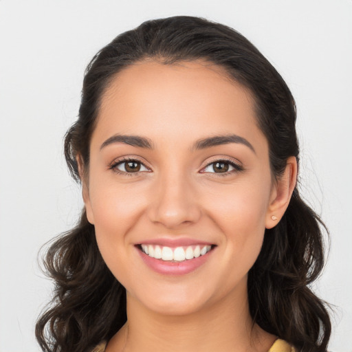 Joyful white young-adult female with long  brown hair and brown eyes