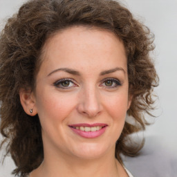 Joyful white young-adult female with medium  brown hair and green eyes